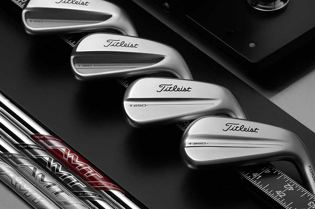 Titleist golf clubs on a black background