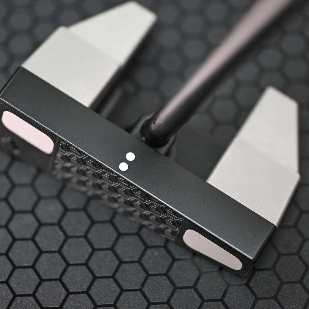 Close-up of a BGT Paradox Mallet Putterwith a black and silver design on a textured black background in Thailand