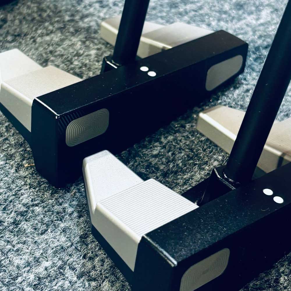 Two BGT Paradox Mallet Putters with black and white design on a textured surface in Bangkok