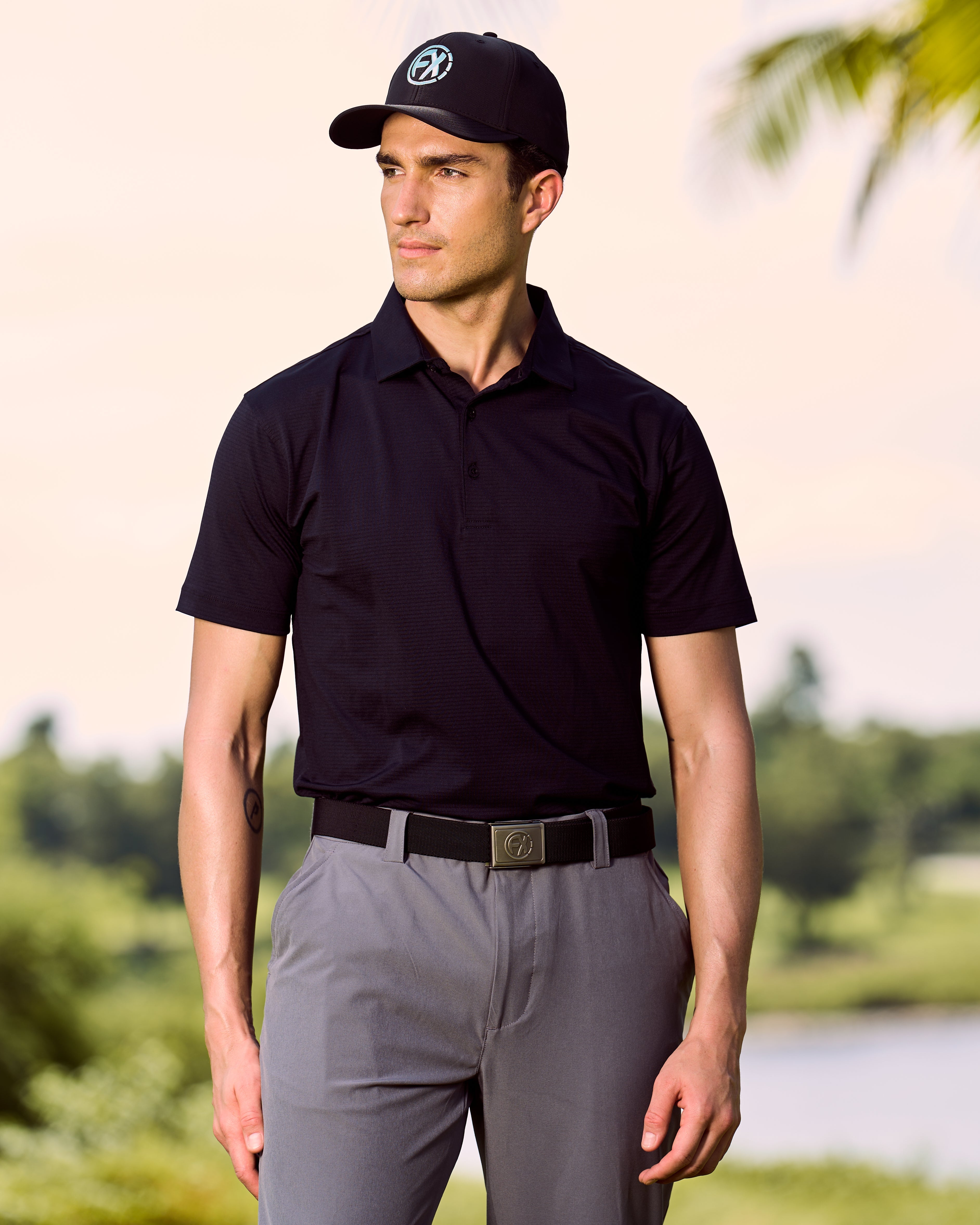 Fenix XCell black performance golf polo featuring moisture-wicking fabric and tailored athletic fit.