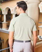 Back view of model in the beige Nantucket performance polo. High quality golf polo shirt designed to be worn from the course to the clubhouse