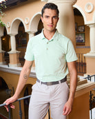 Front view of model in mint golf polo designed for high-performance, with fabric technologies such as sweat-wicking.
