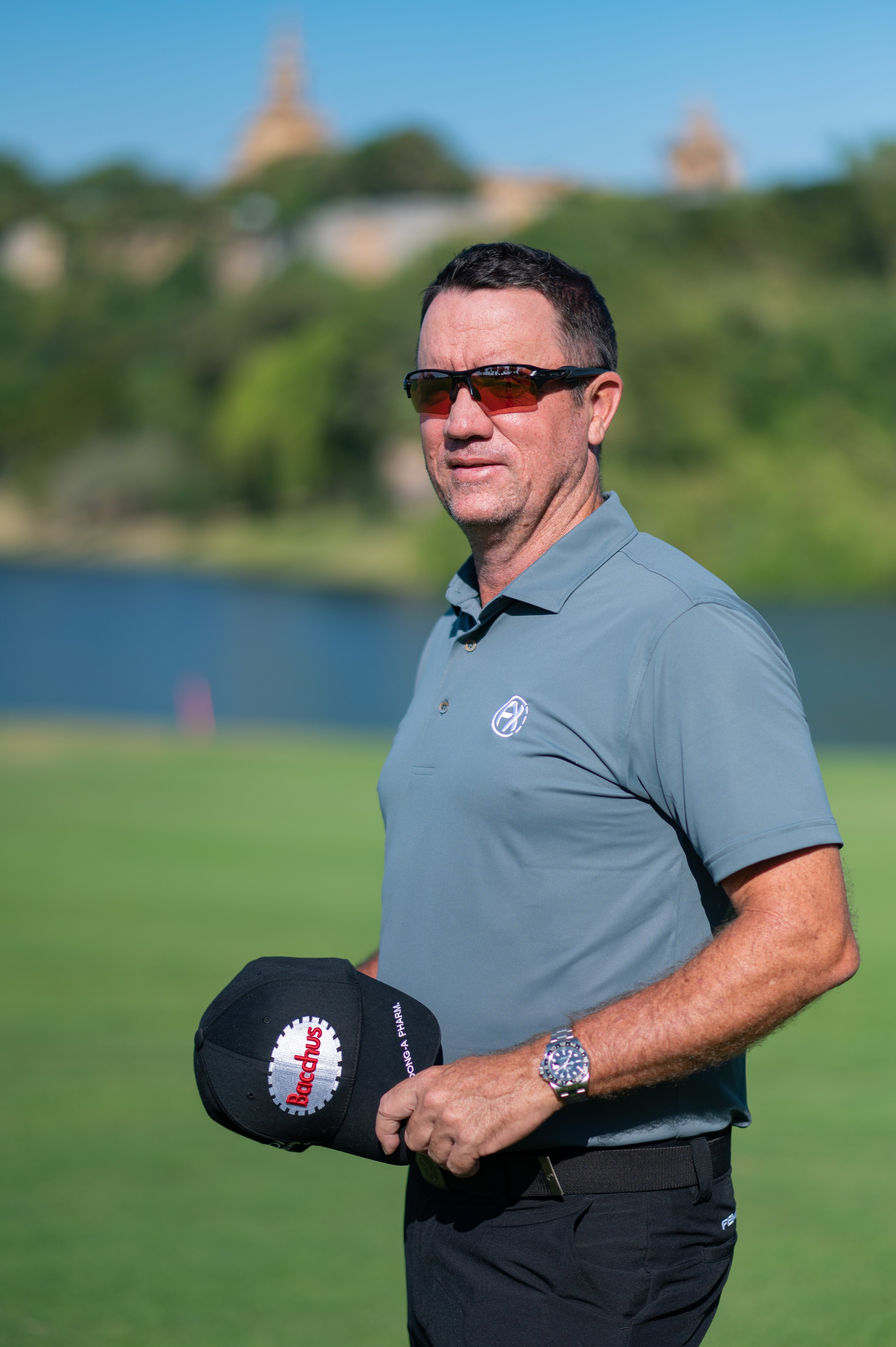 Side profile of golfer in the grey nantucket polo on a golf course. Premium fabric which is sweat-resistant and durable