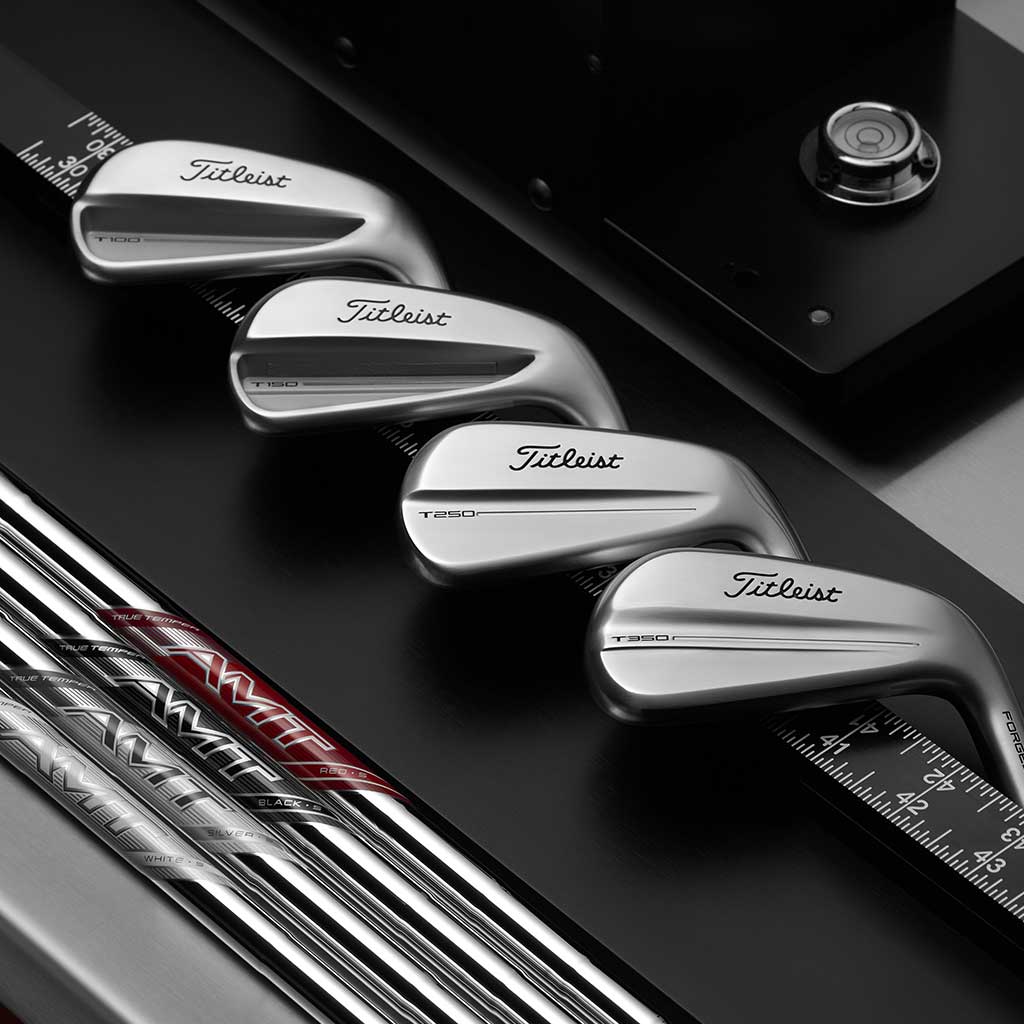Titleist golf clubs on a black background